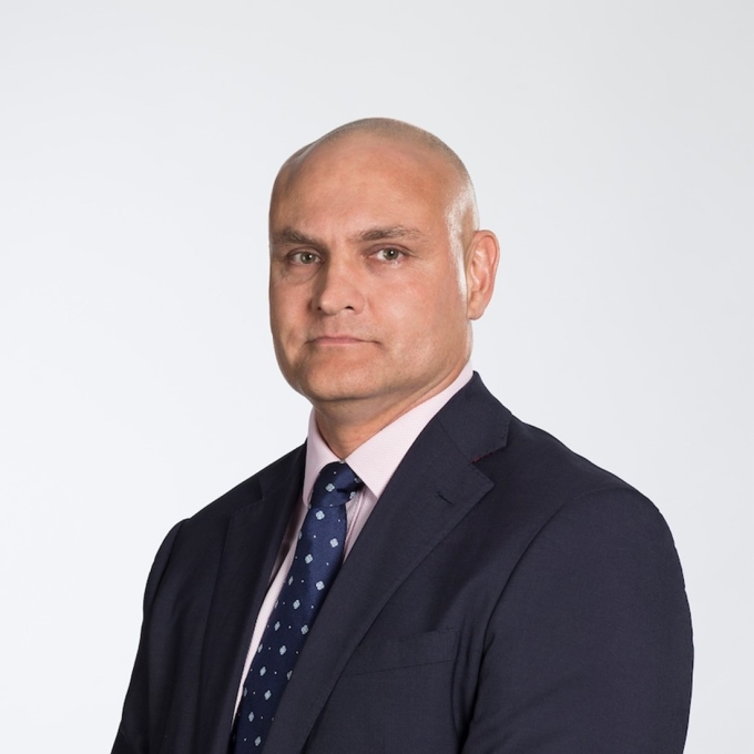 headshot of man wearing a suit