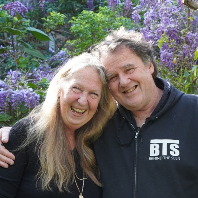 man and woman smiling with arms around eachother