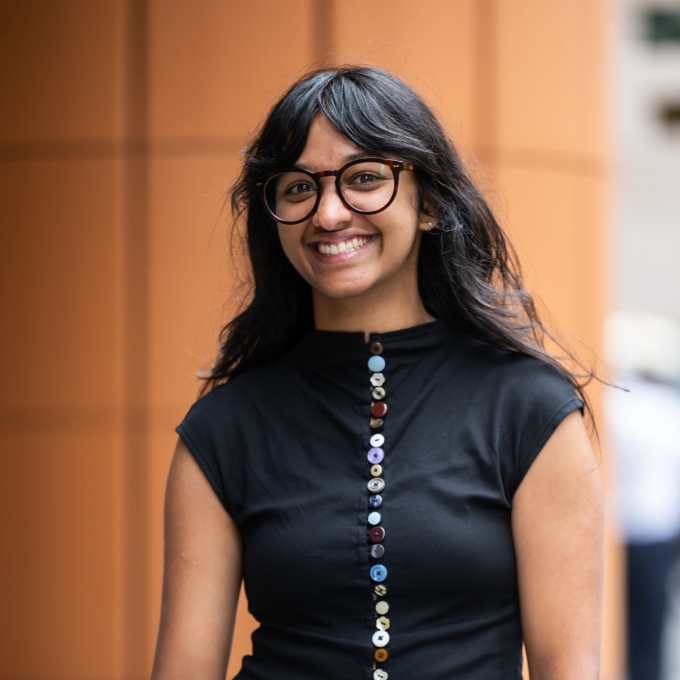Sonali Varma, standing on the steps of an office building in Sydney CBD